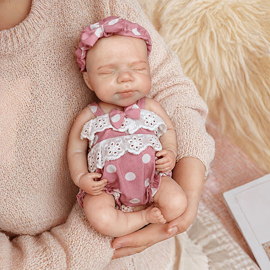 Bambola reborn Pascale 30cm interamente in silicone con occhi chiusi vestita con abiti rosa a pois