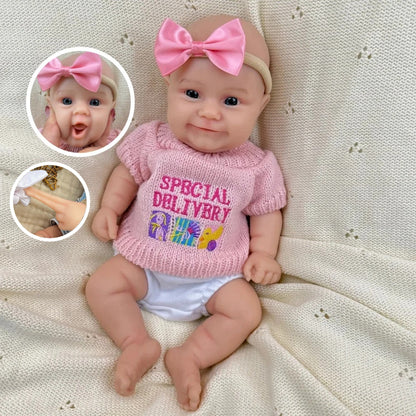 Bambola reborn Maddie Smile da 30cm interamente in silicone con vestitino rosa