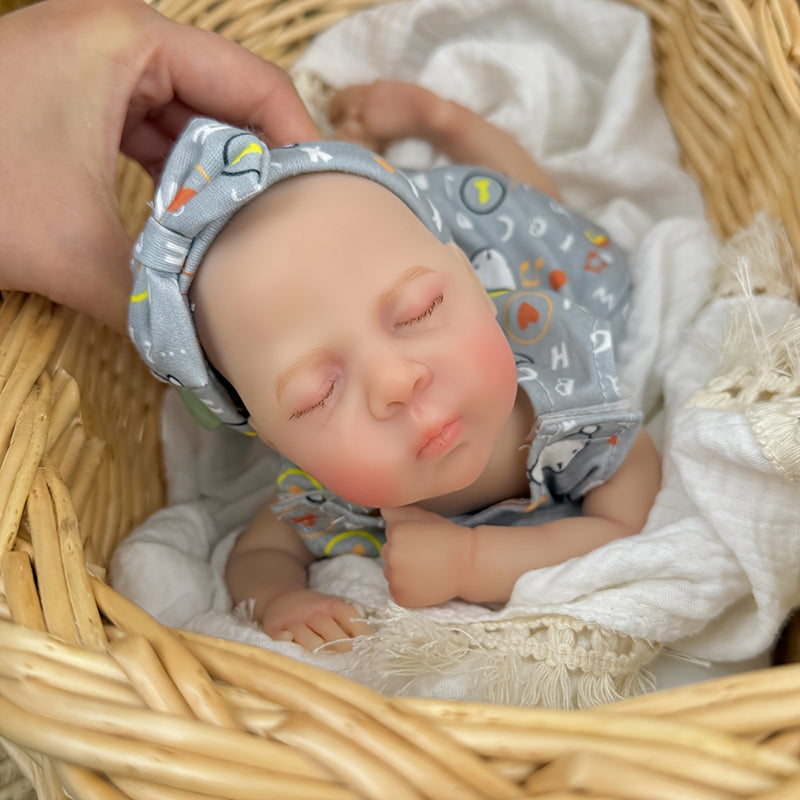 Bambina reborn in silicone realistica di 30 cm Luna con vestito grigio