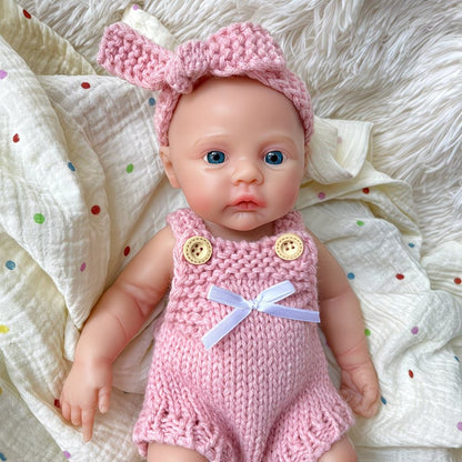 Bambina reborn Meadow in silicone integrale da 30 cm con tutina rosa in maglia