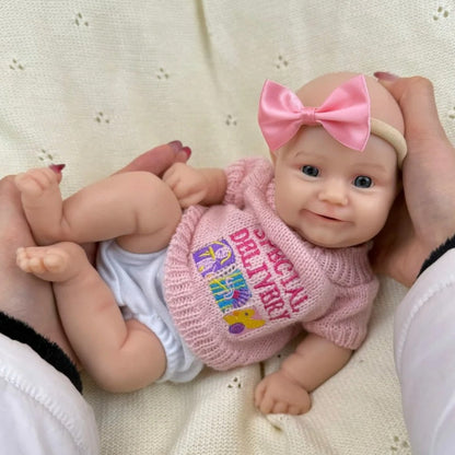 Bambola reborn Maddie Smile da 30cm interamente in silicone con vestitino rosa