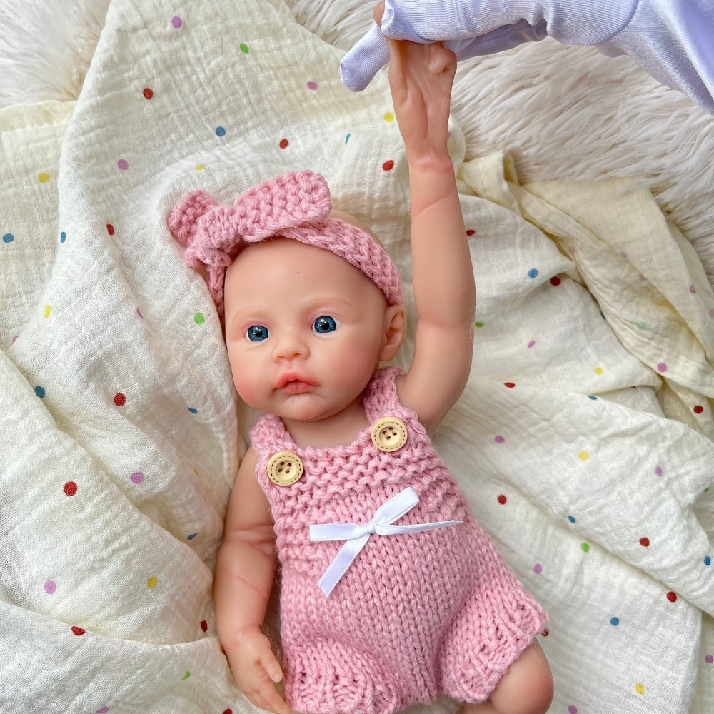 Bambina reborn Meadow in silicone integrale da 30 cm con tutina rosa in maglia