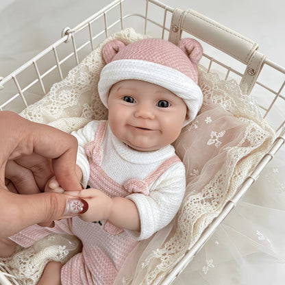 Bambola reborn Maddie Smile da 30 cm interamente in silicone vestita con un orsetto rosa