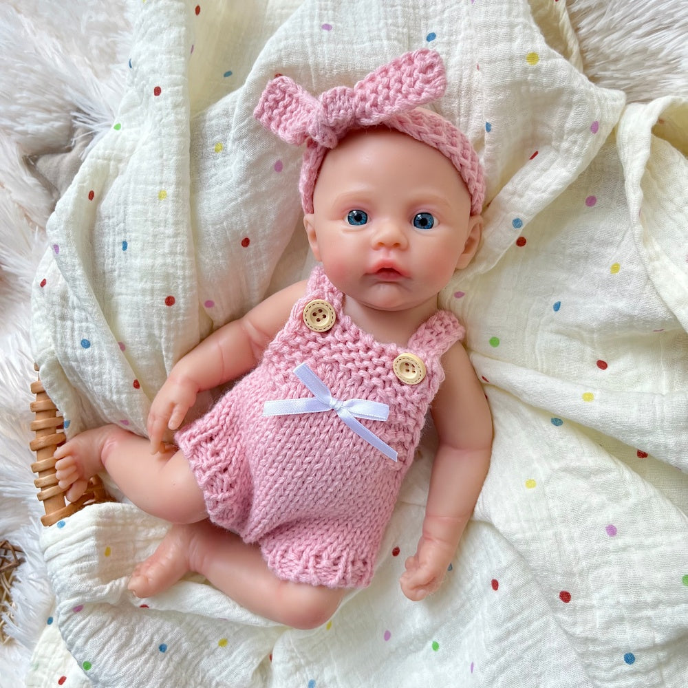 Bambina reborn Meadow in silicone integrale da 30 cm con tutina rosa in maglia