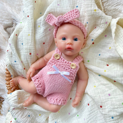 Bambina reborn Meadow in silicone integrale da 30 cm con tutina rosa in maglia