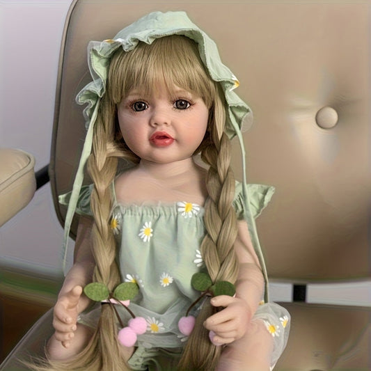 Bambina reborn Betty da 55 cm con occhi aperti e lunghi capelli biondi vestita con un abito verde a margherite