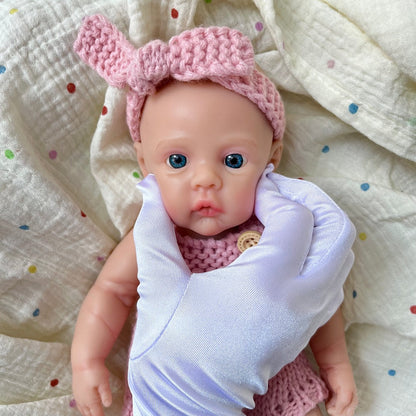 Bambina reborn Meadow in silicone integrale da 30 cm con tutina rosa in maglia