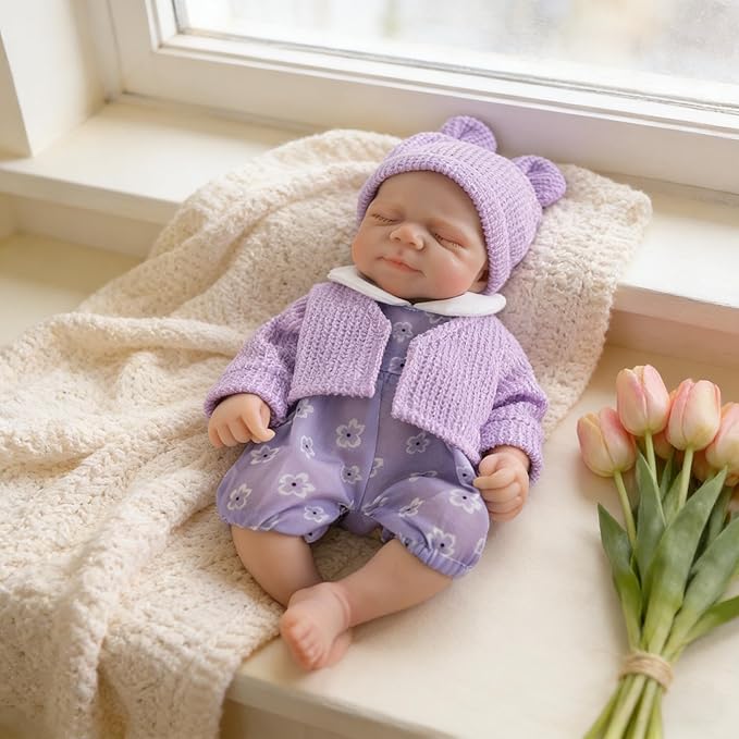 Bambola Reborn Pascale da 30 cm in silicone con bocca apribile con abiti viola