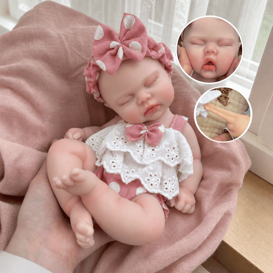 Bambola reborn realistica in morbido silicone alta 30cm con vestitino a pois rosa