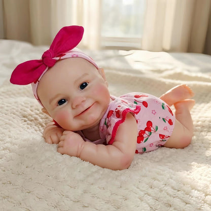 Bambola Reborn femmina Maddie Smile da 30 cm in silicone pieno con completino rosa a fantasia di ciliegie