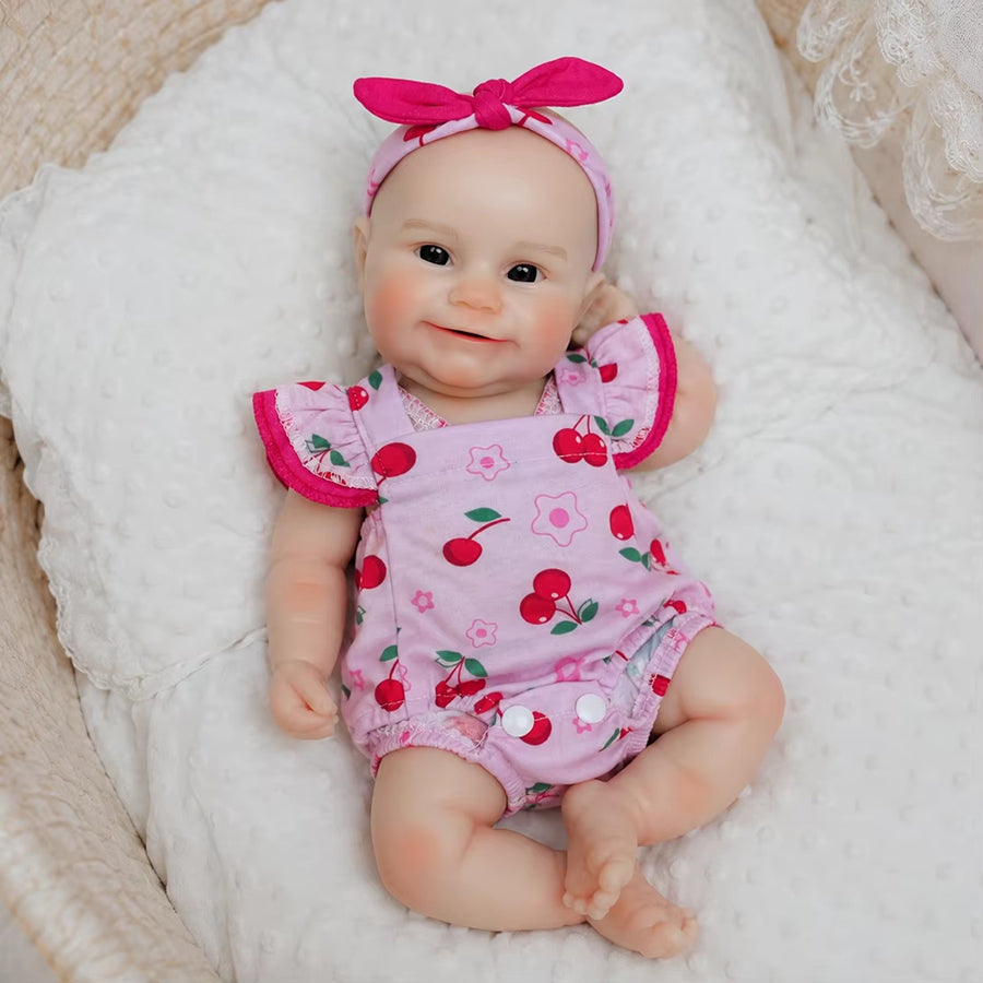 Bambola Reborn femmina Maddie Smile da 30 cm in silicone pieno con completino rosa a fantasia di ciliegie