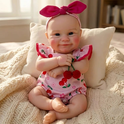 Bambola Reborn femmina Maddie Smile da 30 cm in silicone pieno con completino rosa a fantasia di ciliegie