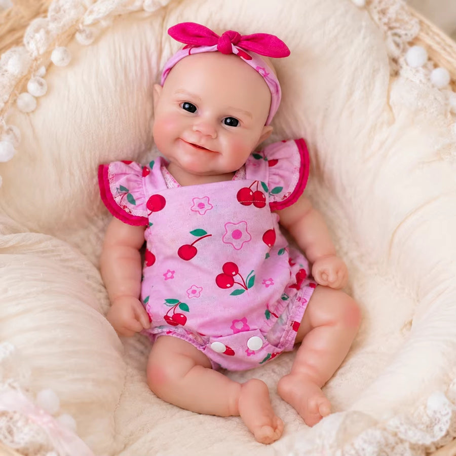 Bambola Reborn femmina Maddie Smile da 30 cm in silicone pieno con completino rosa a fantasia di ciliegie