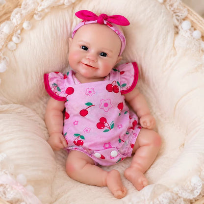 Bambola Reborn femmina Maddie Smile da 30 cm in silicone pieno con completino rosa a fantasia di ciliegie