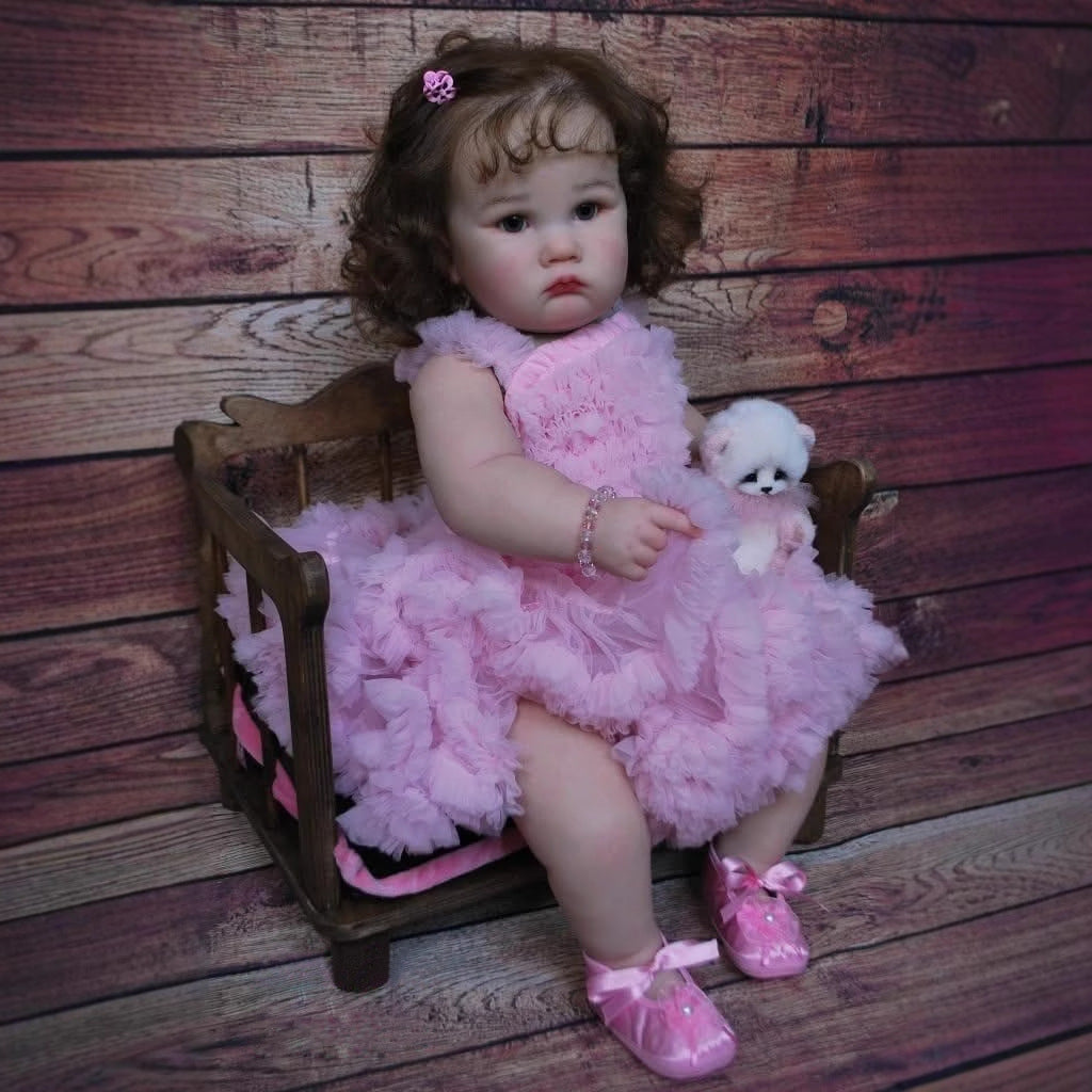 Bambola Reborn Charlotte da 60 cm con occhi aperti e capelli castani in abito rosa