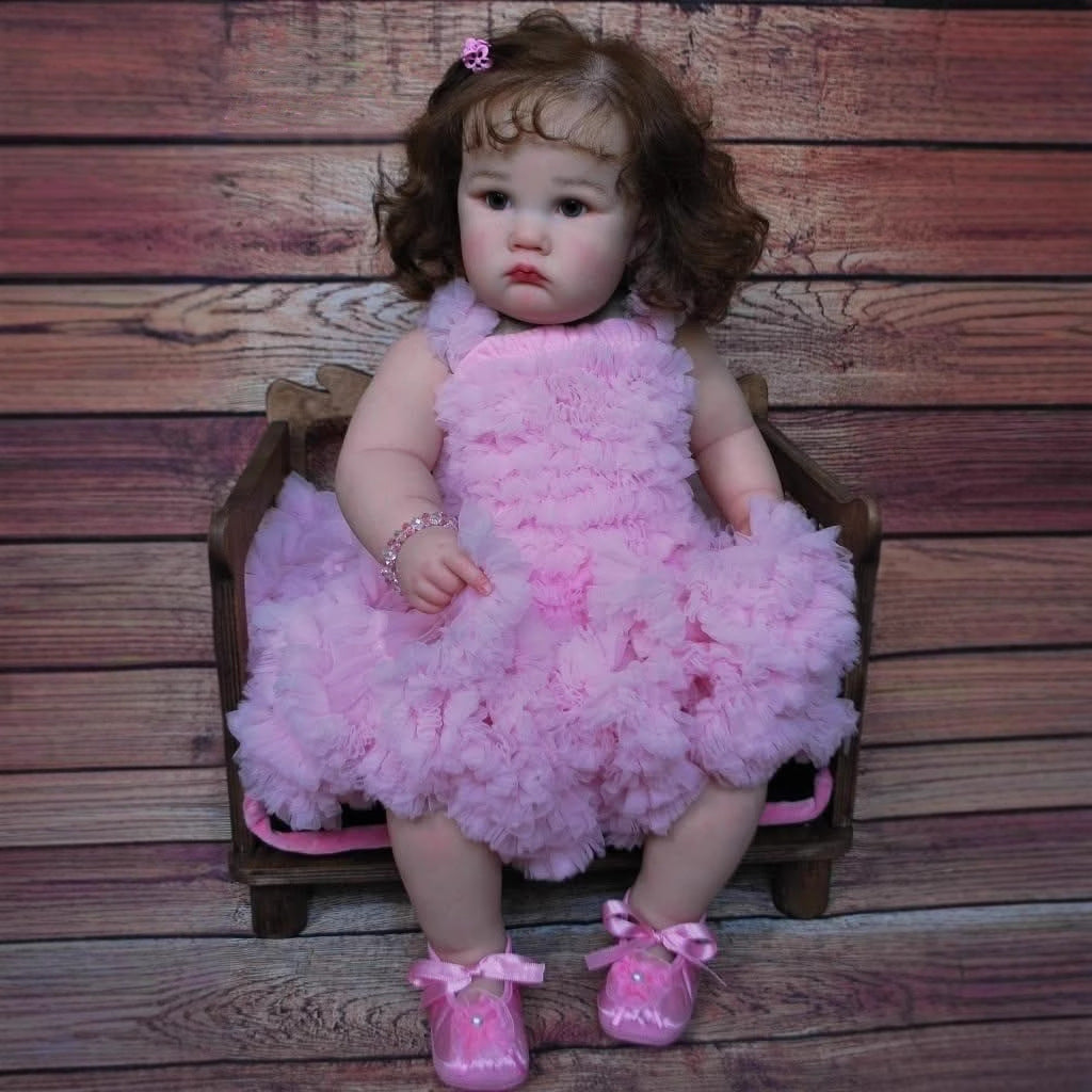 Bambola Reborn Charlotte da 60 cm con occhi aperti e capelli castani in abito rosa