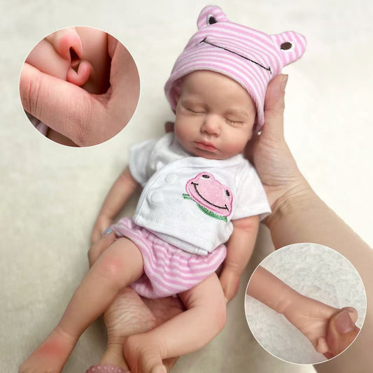 Bambola reborn Loulou bambina addormentata in morbido silicone realistica alta 30cm con indosso abiti rosa a forma di rana