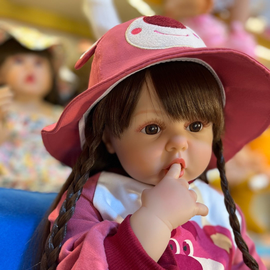 Bambina rinata con capelli lunghi 55 cm/60 cm in abiti rosa da orso