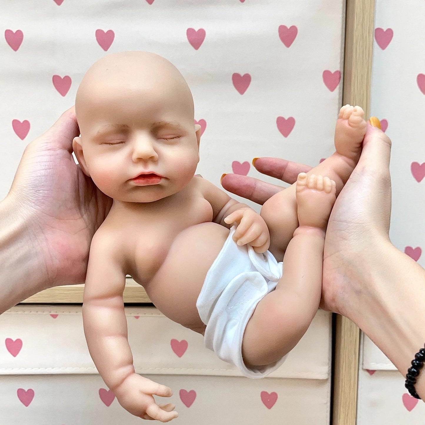 Bambola Reborn da 30 cm realistica completamente in silicone con occhi chiusi in abiti di peluche bianchi