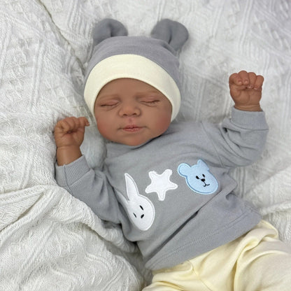 Bambola Reborn Pascale da 48 cm corpo morbido e realistico occhi chiusi pelle scura