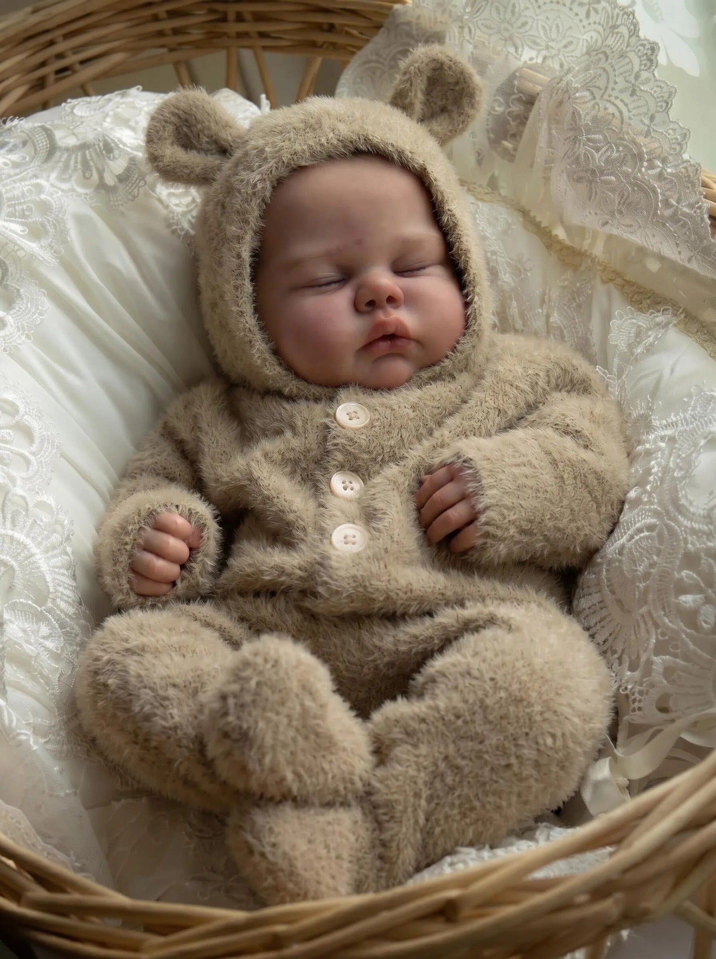 Bambola reborn di 48 cm con corpo morbido modello Pickle Sleeping avvolta in una tutina di peluche color cammello