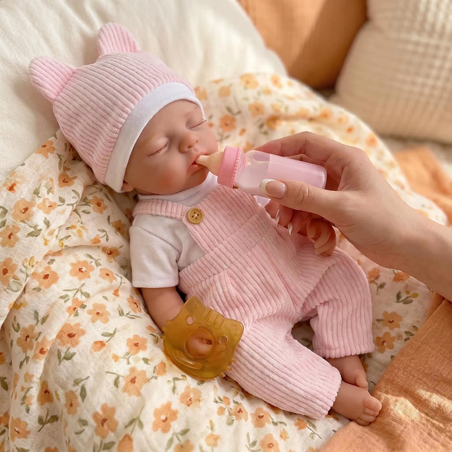 Bambola reborn Irys 30 cm realistica interamente in silicone con abito rosa