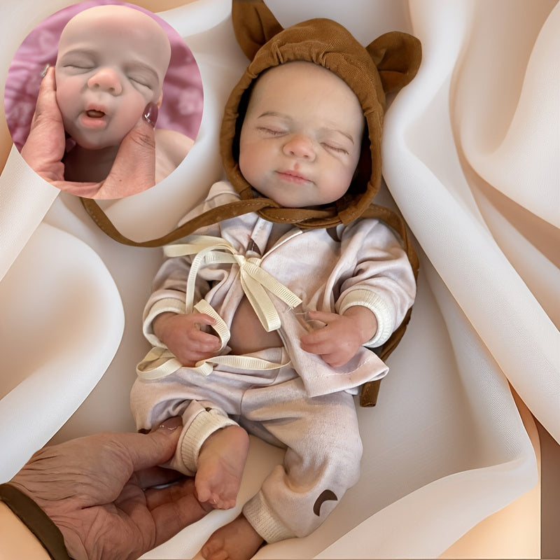 Bambola reborn Pascale in silicone da 30cm con occhi chiusi e vestitino con stampa lunare