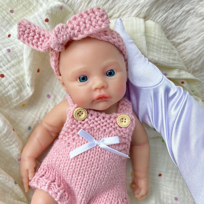 Bambina reborn Meadow in silicone integrale da 30 cm con tutina rosa in maglia