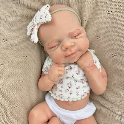 Bambola Reborn Pascale da 45 cm in silicone pieno flessibile dormiente con bavaglino a fiori