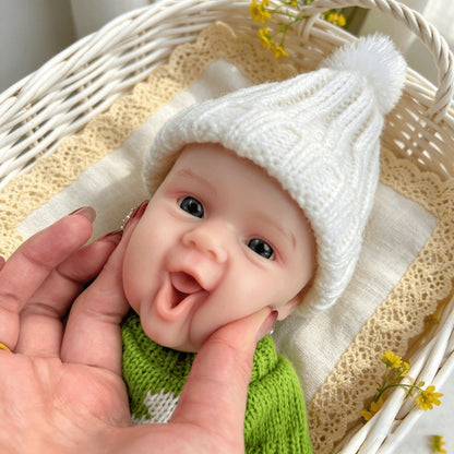 Bambola reborn Maddie Smile da 30 cm interamente in silicone con vestitino verde