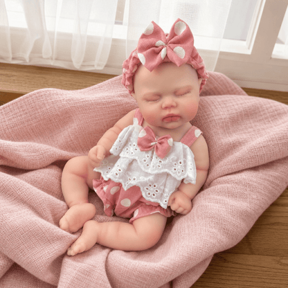 Bambola reborn realistica in morbido silicone alta 30cm con vestitino a pois rosa