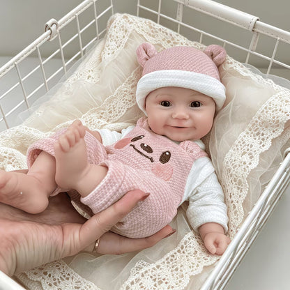 Bambola reborn Maddie Smile da 30 cm interamente in silicone vestita con un orsetto rosa