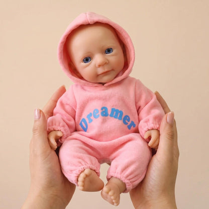 Bambina reborn Felicia da 30cm interamente in silicone con vestitino rosa