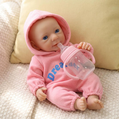 Bambina reborn Felicia da 30cm interamente in silicone con vestitino rosa