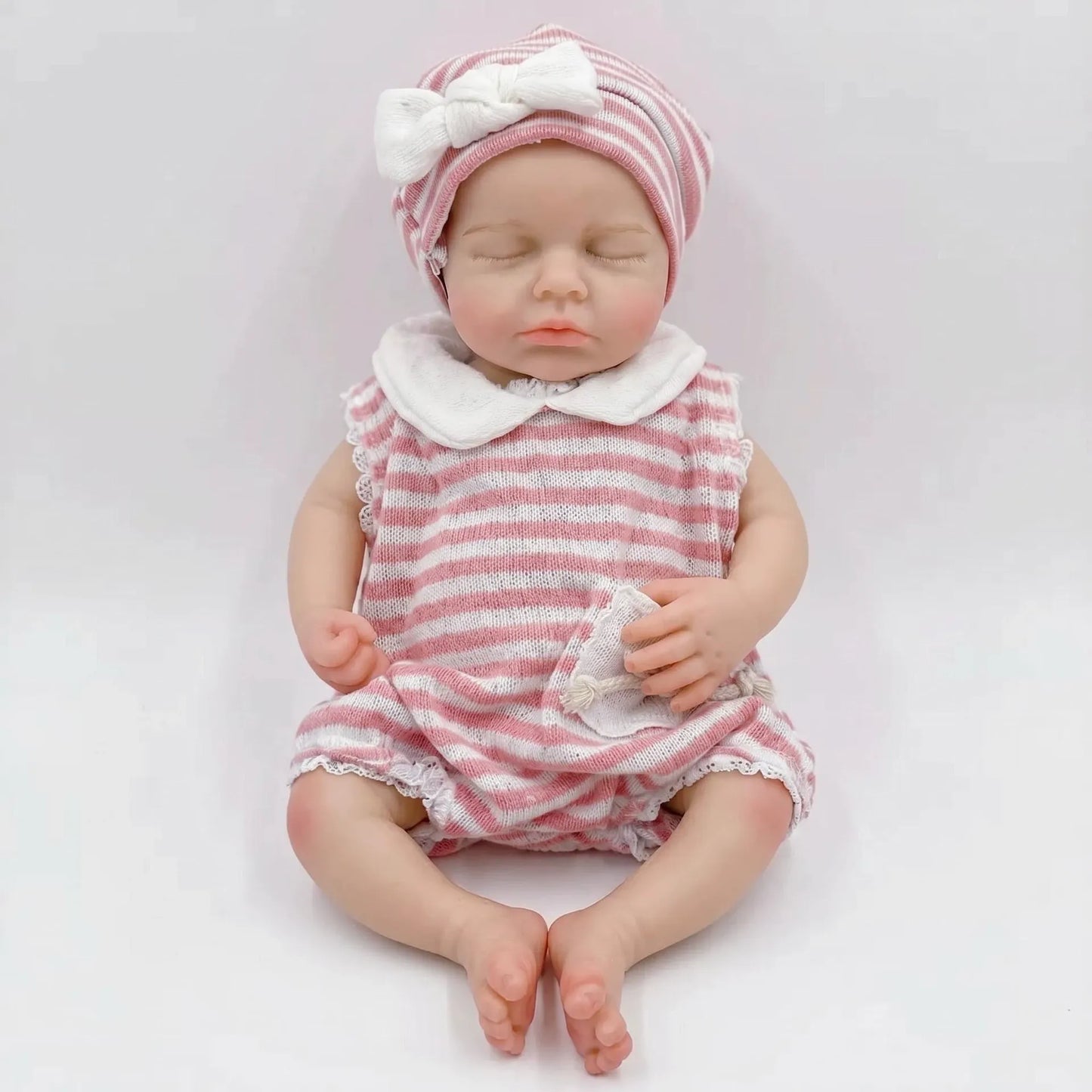 Bambola reborn Loulou da 30cm interamente in silicone con vestitino a righe rosa