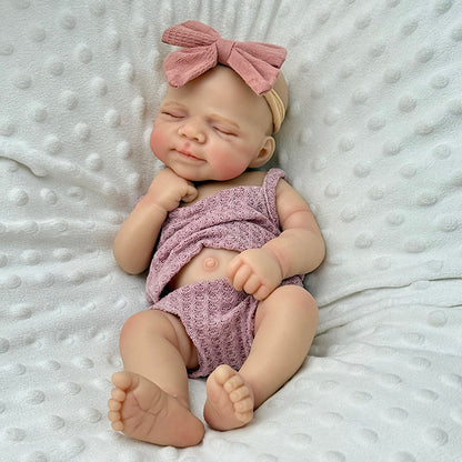 Bambola reborn Pascale 30 cm interamente in silicone con occhi chiusi vestita di viola