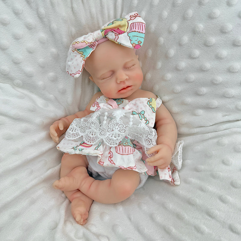 Bambola Reborn Loulou da 30 cm in silicone pieno occhi chiusi con vestitino in pizzo a fiori