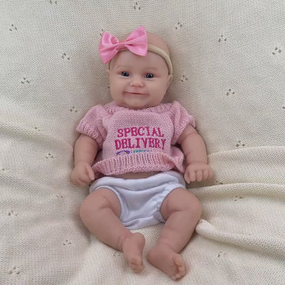 Bambola reborn Maddie Smile da 30cm interamente in silicone con vestitino rosa