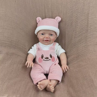 Bambina reborn Charlie alta 30 cm con sorriso realistico e occhi azzurri in silicone vestita con abiti da orsetto rosa
